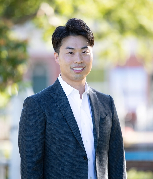Dentist Henry Hur Smiling Outdoors in Suit