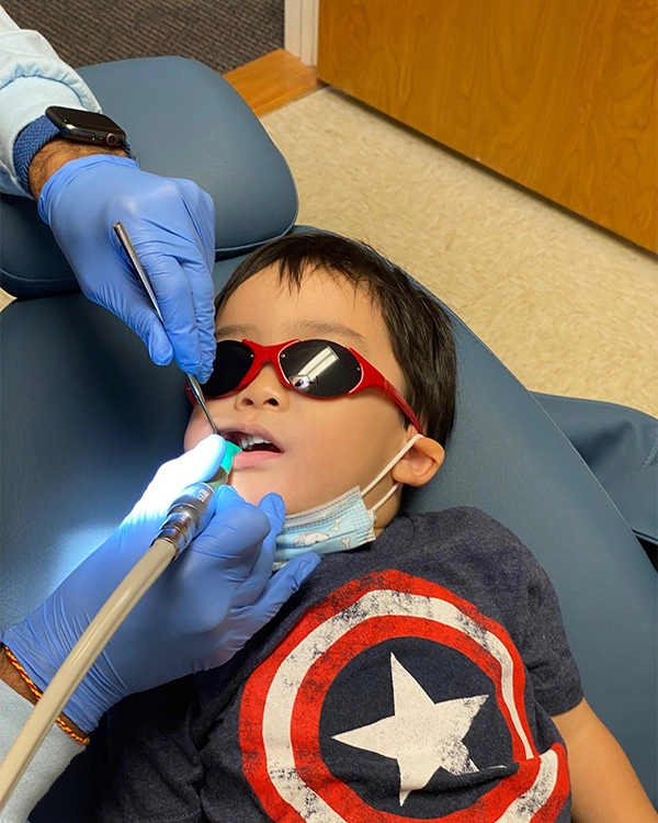 Little Kid In Captain America Shirt Receiving Dental Exam